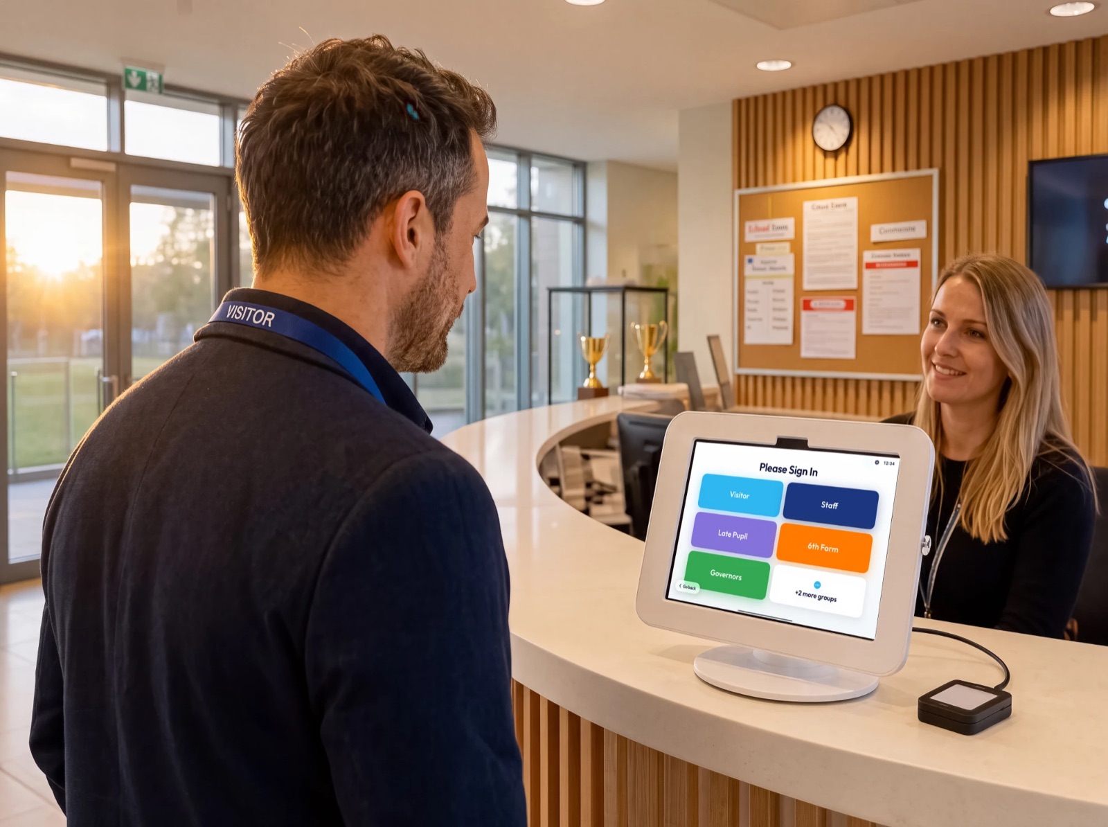 A visitor signing in on the OnSite kiosk at reception